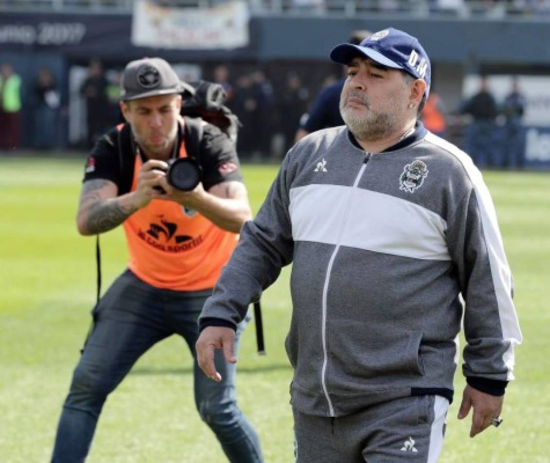 Argentine former football star and new team coach of Gimnasia y Esgrima La Plata Diego Armando Maradona walks during their Argentina First Division Superliga football match against Racing Club, at El Bosque stadium, in La Plata city, Buenos Aires province, Argentina, on September 15, 2019. (Photo by ALEJANDRO PAGNI / AFP)