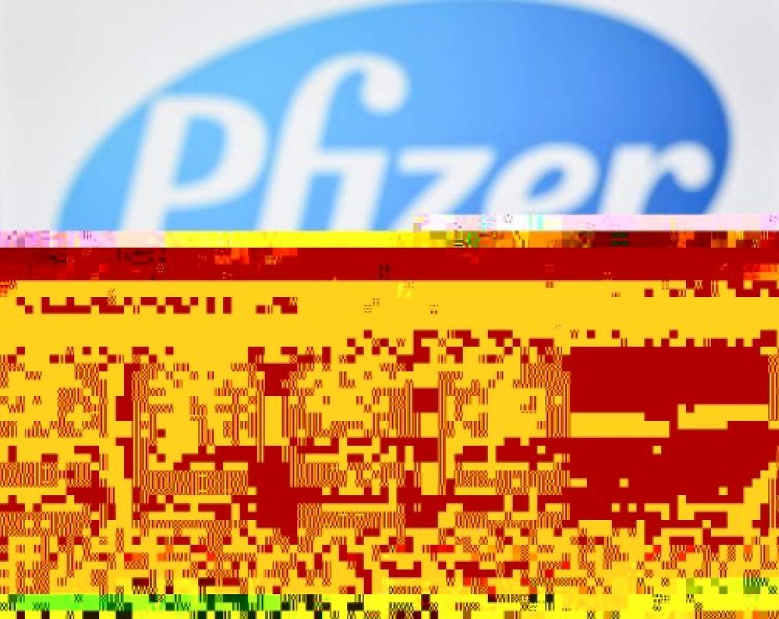 (FILES) This file photo taken on November 17, 2020 shows the logos of US pharmaceutical company Pfizer behind vials with Covid-19 Vaccine stickers attached, as the European Medicines Agency said on December 21, 2020 that it had approved the Pfizer-BioNTech coronavirus vaccine, paving the way for inoculations to start across the EU within days. - The Amsterdam-based regulator dramatically moved the decision on the jab ahead from December 29, following pressure to accelerate the process from Germany and other EU states. (Photo by JUSTIN TALLIS / AFP)