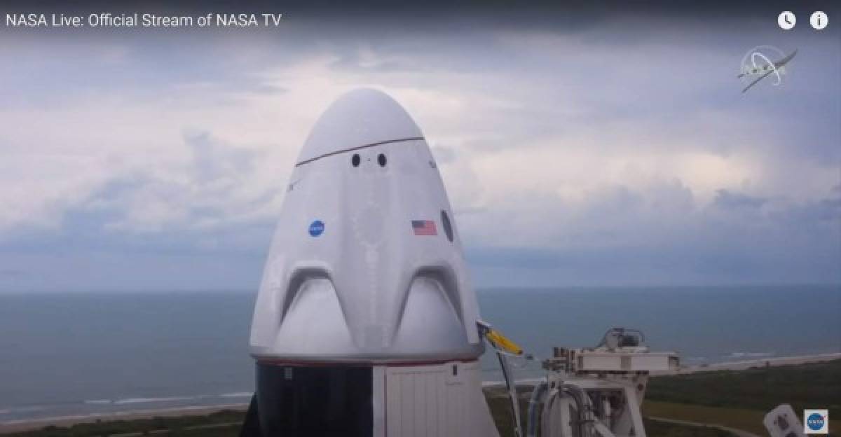 This still image taken from NASA TV, shows the SpaceX Crew Dragon capsule, with astronauts Bob Behnken and Doug Hurley, at Launch Complex 39A in Kennedy Space Center in Florida on May 27, 2020. - The SpaceX-NASA crewed Demo-2 mission has been postponed due to bad weather. (Photo by - / NASA TV / AFP) / RESTRICTED TO EDITORIAL USE - MANDATORY CREDIT 'AFP PHOTO / NASA TV' - NO MARKETING - NO ADVERTISING CAMPAIGNS - DISTRIBUTED AS A SERVICE TO CLIENTS