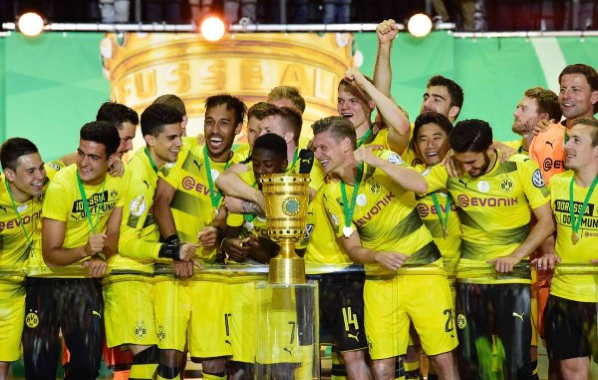 Dortmund's players celebrate with the trophy after winning the German Cup (DFB Pokal) final football match Eintracht Frankfurt v BVB Borussia Dortmund at the Olympic stadium in Berlin on May 27, 2017. / AFP PHOTO / Tobias SCHWARZ / RESTRICTIONS: ACCORDING TO DFB RULES IMAGE SEQUENCES TO SIMULATE VIDEO IS NOT ALLOWED DURING MATCH TIME. MOBILE (MMS) USE IS NOT ALLOWED DURING AND FOR FURTHER TWO HOURS AFTER THE MATCH. == RESTRICTED TO EDITORIAL USE == FOR MORE INFORMATION CONTACT DFB DIRECTLY AT +49 69 67880 /