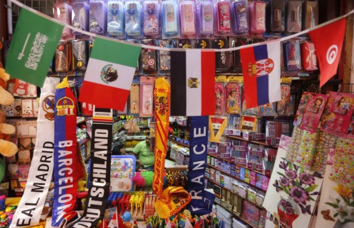 A picture taken on June 7, 2018 shows flags of countries participating in the upcoming 2018 FIFA World Cup on display among other flags outside a vendor's stall to be sold for football supporters and viewers, at a market street in the old city of the Syrian capital Damascus. / AFP PHOTO / LOUAI BESHARA