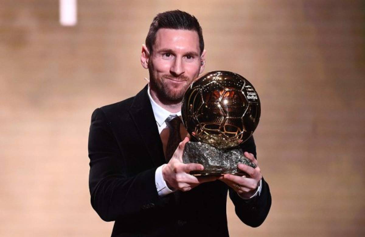 Barcelona's Argentinian forward Lionel Messi reacts after winning the Ballon d'Or France Football 2019 trophy at the Chatelet Theatre in Paris on December 2, 2019. - Lionel Messi won a record-breaking sixth Ballon d'Or on Monday after another sublime year for the Argentinian, whose familiar brilliance remained undimmed even through difficult times for club and country. (Photo by FRANCK FIFE / AFP)