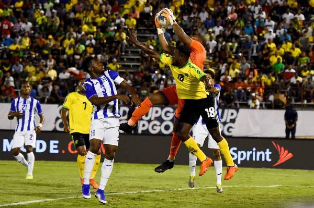 Jamaica's Brian Brown (#18) fights for the ball with Honduras's Maynor Figueroa (#3) during the 2019 Concacaf Gold Cup match between Jamaica and Honduras, on June 17, 2019 at Independence Park in Kingston. (Photo by CHANDAN KHANNA / AFP)