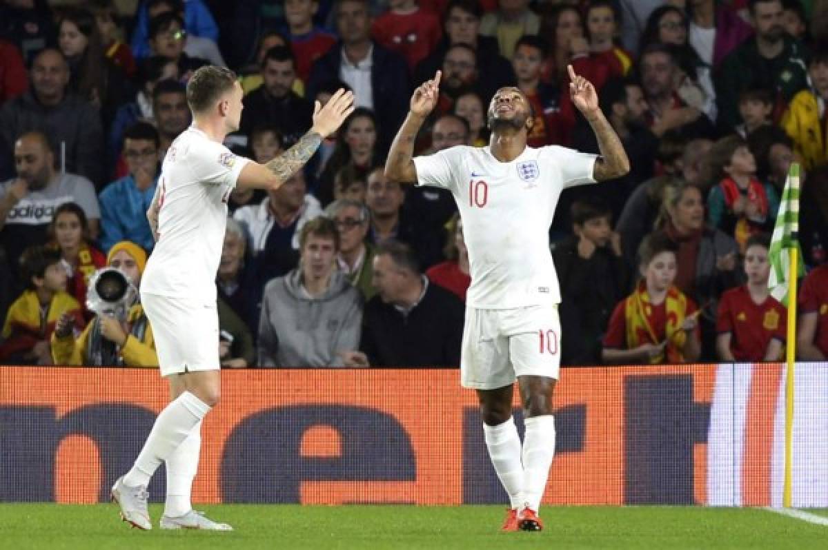 England's forward Raheem Sterling (R) celebrates after scoring a goal during the UEFA Nations League football match between Spain and England on October 15, 2018 at the Benito Villamarin stadium in Sevilla. (Photo by CRISTINA QUICLER / AFP)