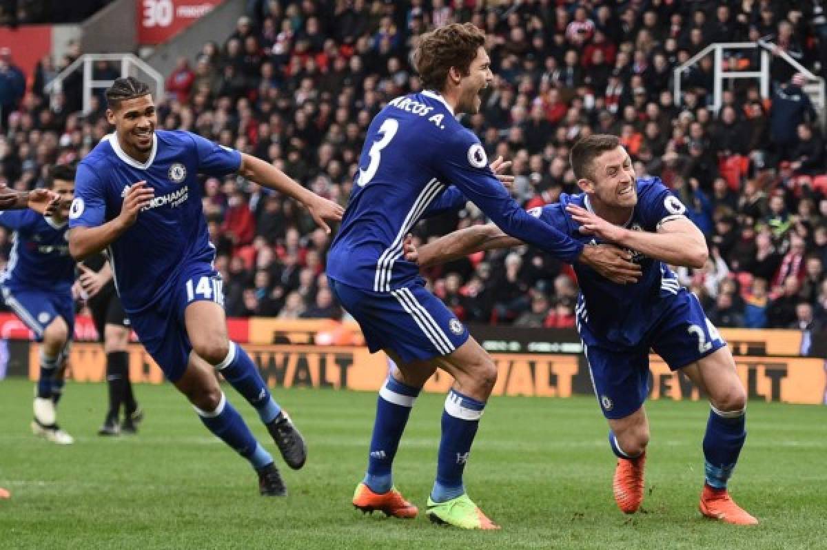 Chelsea's English defender Gary Cahill (R) celebrates with Chelsea's Spanish defender Marcos Alonso after scoring during the English Premier League football match between Stoke City and Chelsea at the Bet365 Stadium in Stoke-on-Trent, central England on March 18, 2017. / AFP PHOTO / Oli SCARFF / RESTRICTED TO EDITORIAL USE. No use with unauthorized audio, video, data, fixture lists, club/league logos or 'live' services. Online in-match use limited to 75 images, no video emulation. No use in betting, games or single club/league/player publications. /