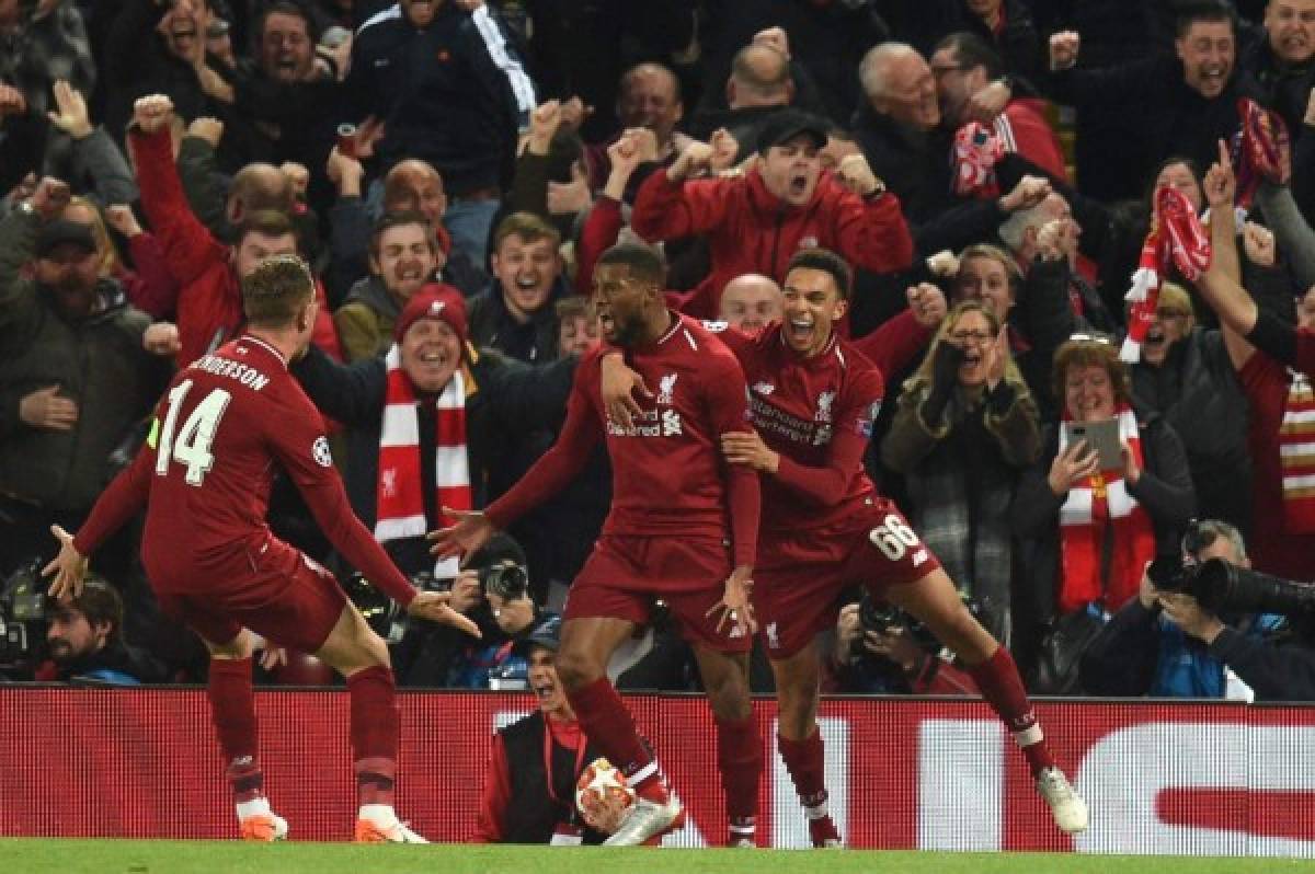 Liverpool's Dutch midfielder Georginio Wijnaldum (C) celebrates with Liverpool's English midfielder Jordan Henderson (L) and Liverpool's English defender Trent Alexander-Arnold after scoring their third goal during the UEFA Champions league semi-final second leg football match between Liverpool and Barcelona at Anfield in Liverpool, north west England on May 7, 2019. (Photo by Oli SCARFF / AFP)