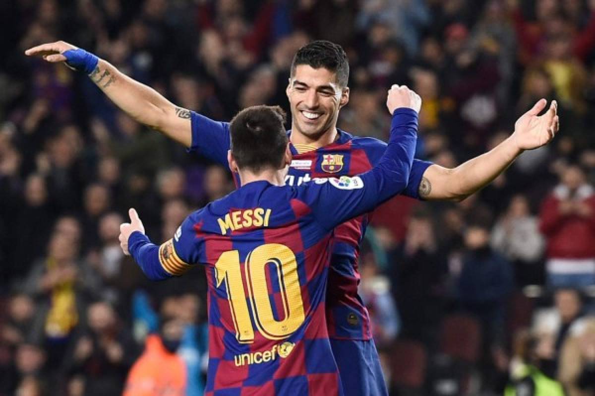 Barcelona's Argentine forward Lionel Messi celebrates his third goal with Barcelona's Uruguayan forward Luis Suarez during the Spanish League football match between FC Barcelona and RCD Mallorca at the Camp Nou stadium in Barcelona on December 7, 2019. (Photo by Josep LAGO / AFP)