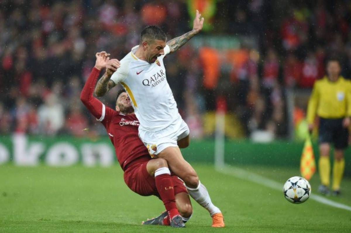 (FILES) In this file photo taken on April 24, 2018 Liverpool's English midfielder Alex Oxlade-Chamberlain (L) picks up an injury tackling Roma's Croatian defender Aleksandar Kolarov during the UEFA Champions League first leg semi-final football match between Liverpool and Roma at Anfield stadium in Liverpool, north west England on April 24, 2018.England midfielder Alex Oxlade-Chamberlain will miss the World Cup after he suffered a knee ligament injury in Liverpool's Champions League semi-final clash with Roma, the club said on April 25, 2018. / AFP PHOTO / Oli SCARFF