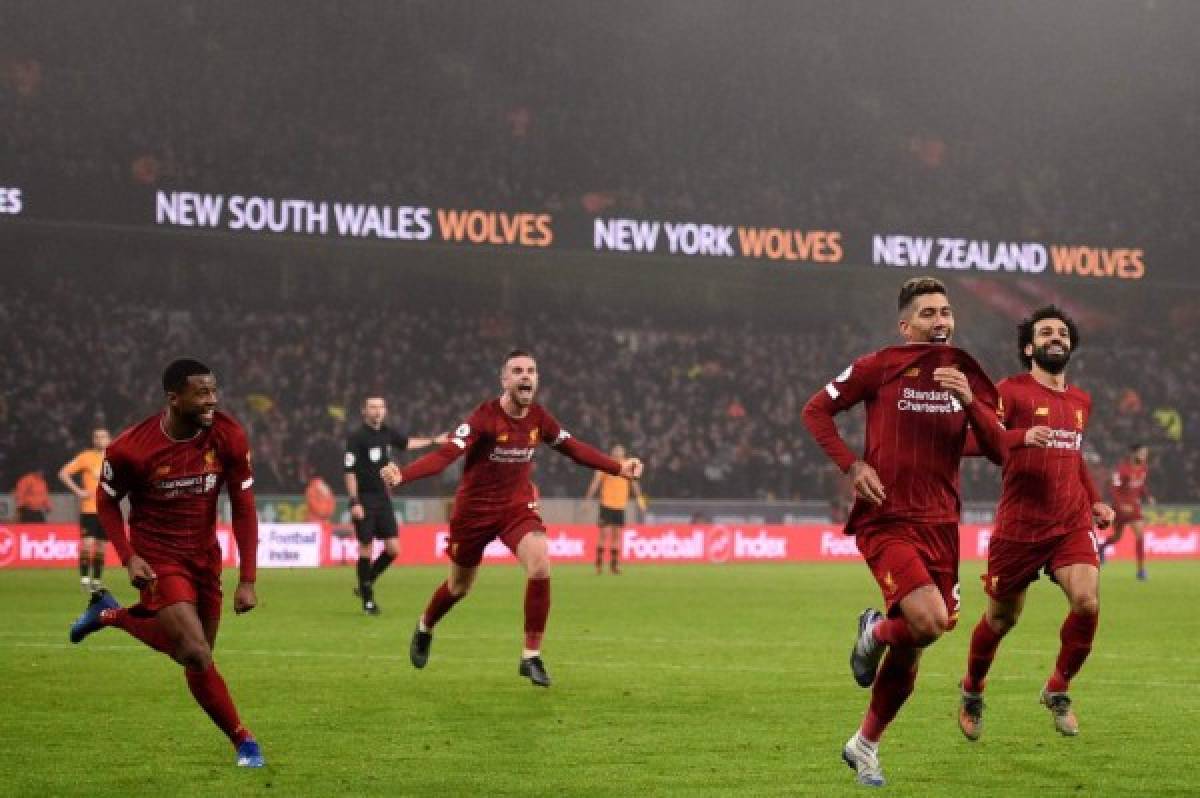 Liverpool's Brazilian midfielder Roberto Firmino (2R) celebrates after he scores the team's second goal during the English Premier League football match between Wolverhampton Wanderers and Liverpool at the Molineux stadium in Wolverhampton, central England on January 23, 2020. (Photo by Oli SCARFF / AFP) / RESTRICTED TO EDITORIAL USE. No use with unauthorized audio, video, data, fixture lists, club/league logos or 'live' services. Online in-match use limited to 120 images. An additional 40 images may be used in extra time. No video emulation. Social media in-match use limited to 120 images. An additional 40 images may be used in extra time. No use in betting publications, games or single club/league/player publications. /