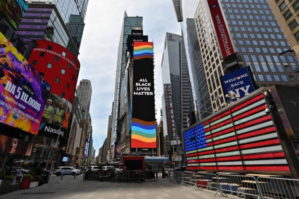 NEW YORK, NEW YORK - JUNE 24: Billboards light up with 'All Black Lives Matter' message and a Pride flag in Times Square on June 24, 2020 in New York City. Due to the ongoing Coronavirus pandemic, this year's pride march had to be canceled over health concerns. The annual event, which sees millions of attendees, marks it's 50th anniversary since the first march following the Stonewall Inn riots. Dia Dipasupil/Getty Images/AFP
