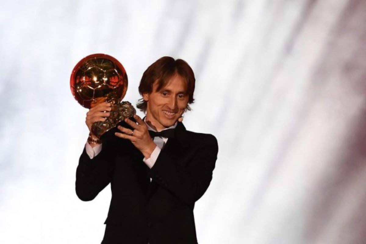 Real Madrid's Croatian midfielder Luka Modric brandishes the trophy after receiving the 2018 FIFA Men's Ballon d'Or award for best player of the year during the 2018 FIFA Ballon d'Or award ceremony at the Grand Palais in Paris on December 3, 2018. - The winner of the 2018 Ballon d'Or will be revealed at a glittering ceremony in Paris on December 3 evening, with Croatia's Luka Modric and a host of French World Cup winners all hoping to finally end the 10-year duopoly of Cristiano Ronaldo and Lionel Messi. (Photo by FRANCK FIFE / AFP)