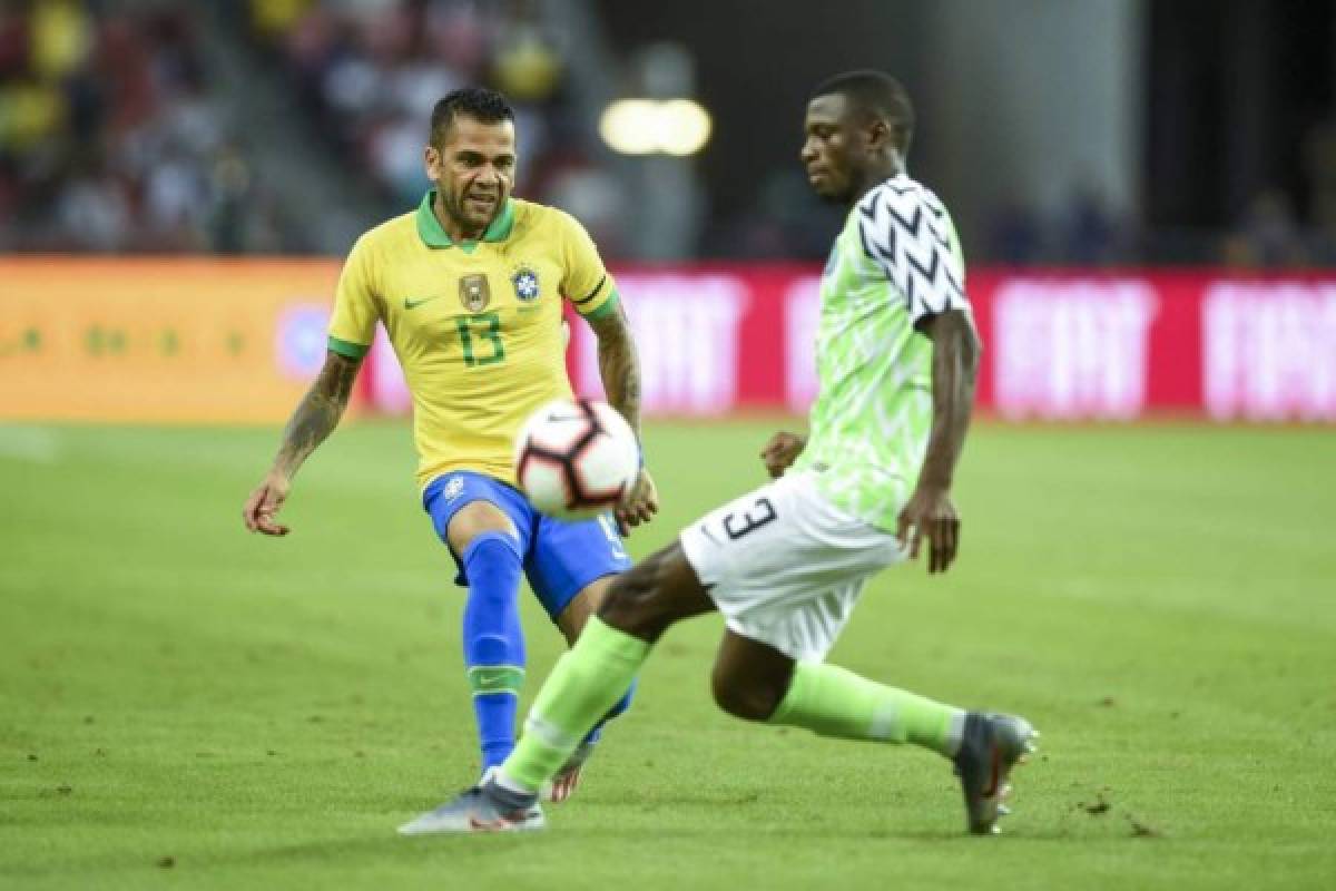 Dani Alves ante la marca férrea de uno de los defensores de Nigeria durante el encuentro amistoso de este domingo.