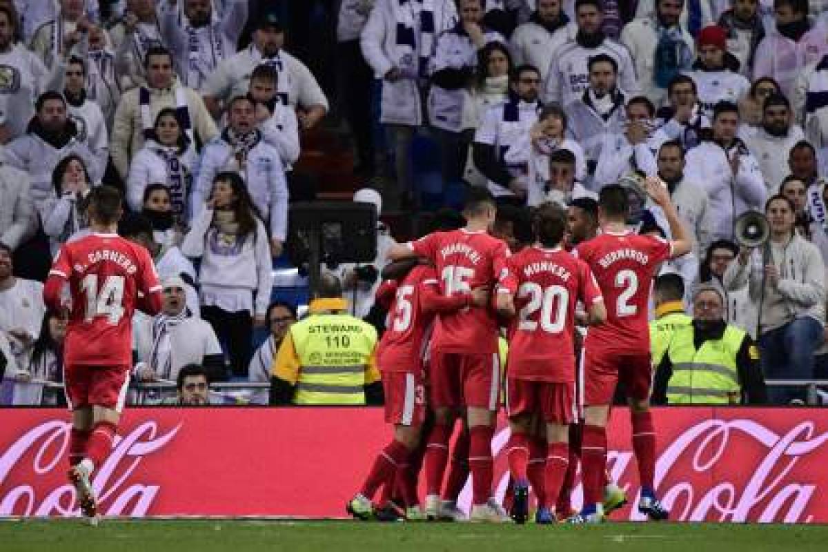 Girona's players celebrate after Spanish midfielder Alex Granell scored a penalty during the Spanish Copa del Rey (King's Cup) quarter-final first leg football match between Real Madrid CF and Girona FC at the Santiago Bernabeu stadium in Madrid on January 24, 2019. (Photo by JAVIER SORIANO / AFP)