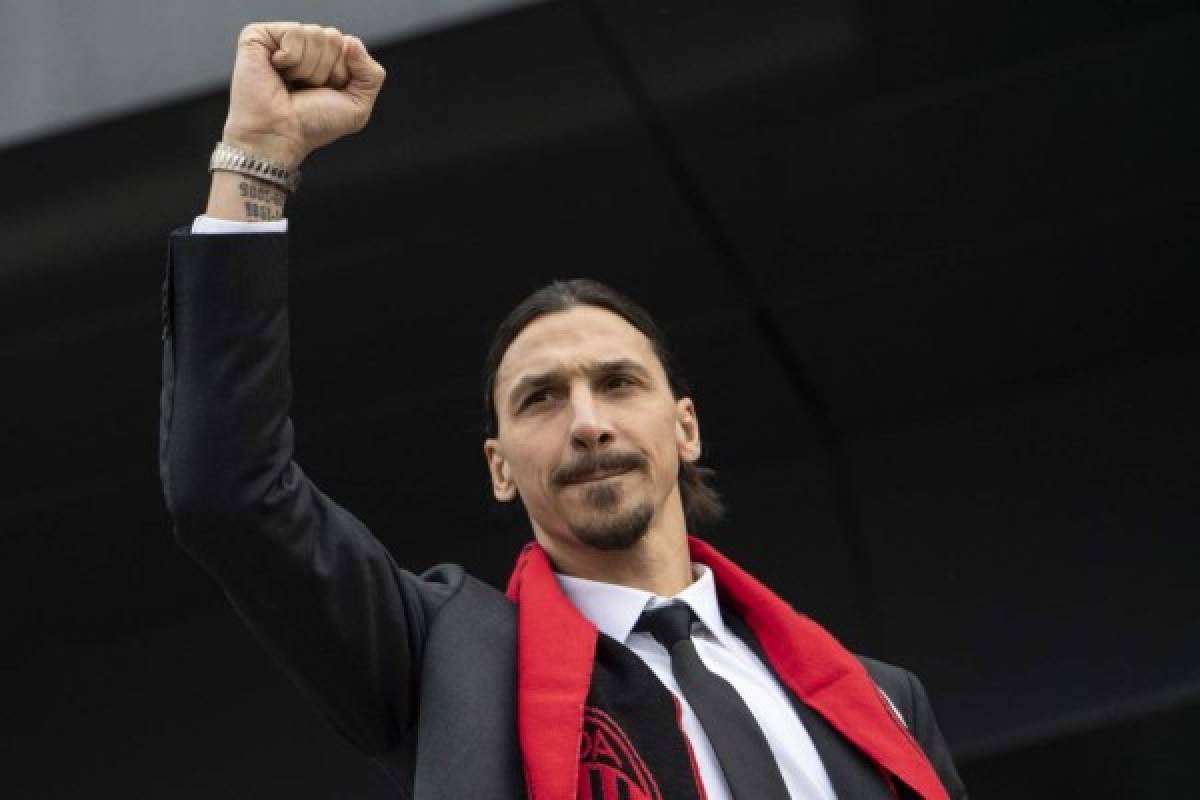 Milan's Swedish forward Zlatan Ibrahimovic reacts as he receives his new jersey during his official presentation as new AC Milan player at the club's headquarters Casa Milan in Milan on January 3, 2019. - Ibrahimovic returns to the side on a six-month deal, promising to help rescue the struggling Serie A outfit's season. (Photo by MARCO BERTORELLO / AFP)