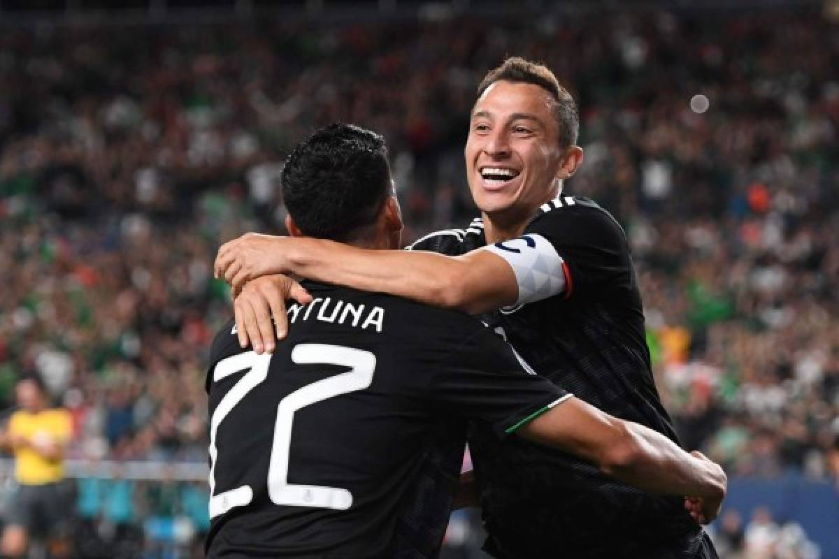 Mexico's midfielder Andres Guardado (R) celebrates with Mexico's forward Uriel Antuna after scoring a goal during the CONCACAF Gold Cup Group A match between Mexico and Canada on June 19, 2019 at Broncos Mile High stadium in Denver, Colorado. (Photo by Robyn Beck / AFP)