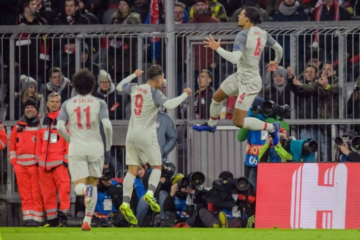 Liverpool's Dutch defender Virgil van Dijk celebrates scoring the 1-2 goal with his team-mates during the UEFA Champions League, last 16, second leg football match Bayern Munich v Liverpool in Munich, southern Germany, on March 13, 2019. (Photo by GUENTER SCHIFFMANN / AFP)
