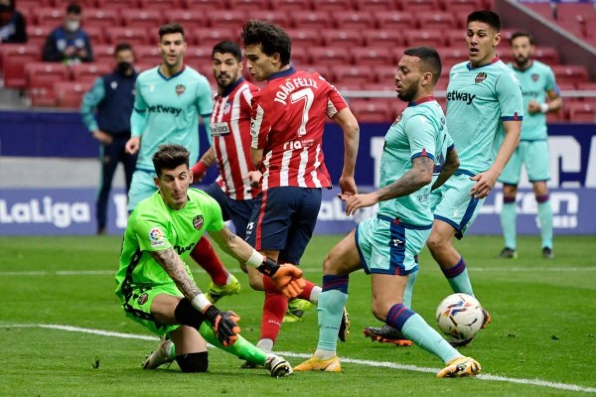 Levante's Spanish goalkeeper Dani Cardenas (L) clears the ball during the Spanish league football match between Club Atletico de Madrid and Levante UD at the Wanda Metropolitano stadium in Madrid on February 20, 2021. (Photo by JAVIER SORIANO / AFP)