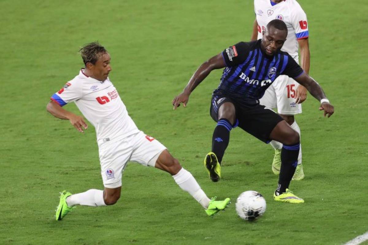 ORLANDO, FL - DECEMBER 15: Javier Portillo #25 (L) of CD Olimpia competes for the ball against Zachary Brault-Guillard #15 of Montreal Impact during the CONCACAF Champions League quarterfinal game at Exploria Stadium on December 15, 2020 in Orlando, Florida. Alex Menendez/Getty Images/AFP== FOR NEWSPAPERS, INTERNET, TELCOS & TELEVISION USE ONLY ==