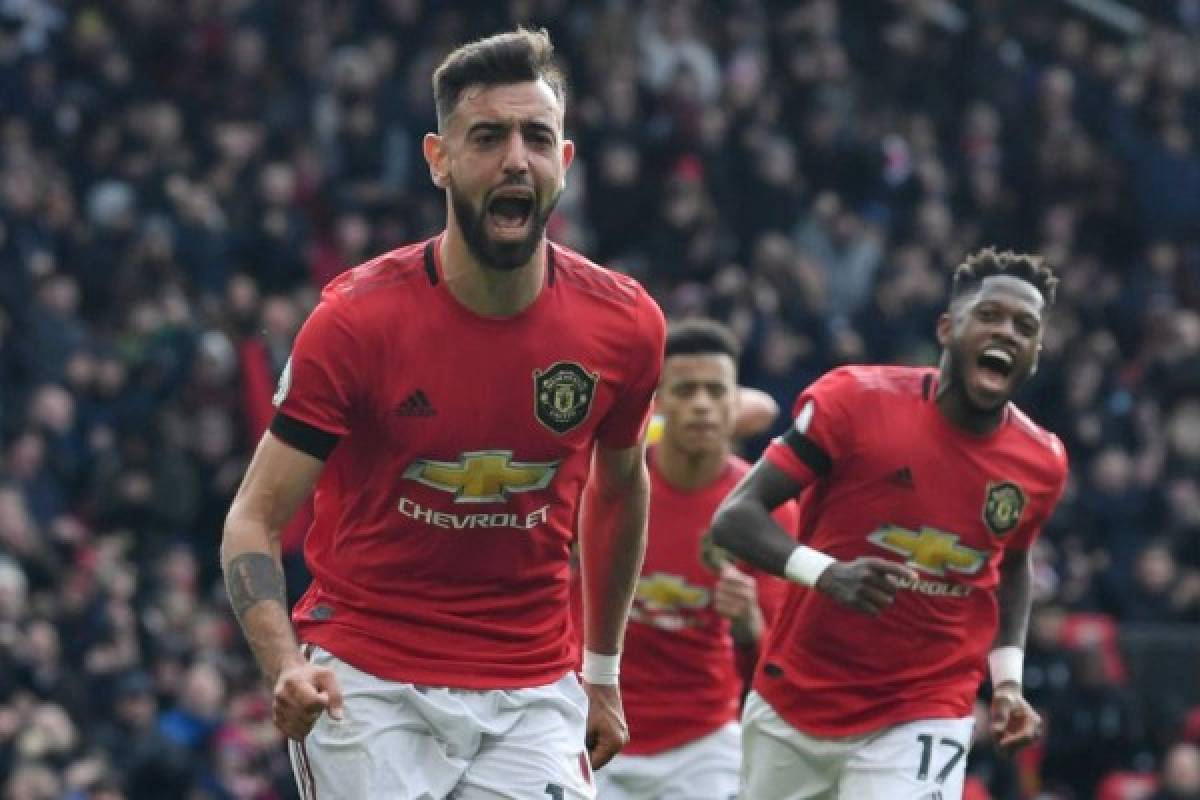 Manchester United's Portuguese midfielder Bruno Fernandes celebrates scoring the opening goal from the penalty spot during the English Premier League football match between Manchester United and Watford at Old Trafford in Manchester, north west England, on February 23, 2020. (Photo by Paul ELLIS / AFP) / RESTRICTED TO EDITORIAL USE. No use with unauthorized audio, video, data, fixture lists, club/league logos or 'live' services. Online in-match use limited to 120 images. An additional 40 images may be used in extra time. No video emulation. Social media in-match use limited to 120 images. An additional 40 images may be used in extra time. No use in betting publications, games or single club/league/player publications. /