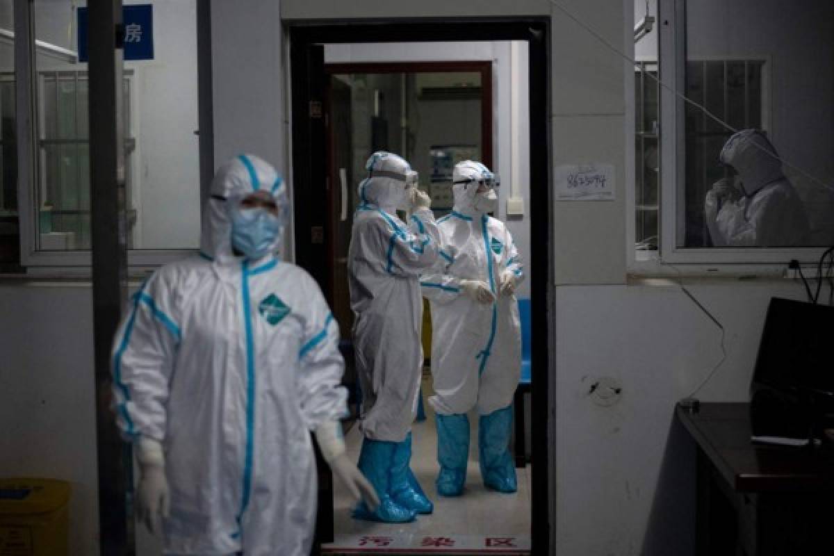 Medical workers wearing hazmat suits as a preventive measure against the COVID-19 coronavirus are seen at a fever clinic in Huanggang Zhongxin Hospital in Huanggang, in China’s central Hubei province on March 26, 2020. (Photo by NOEL CELIS / AFP)