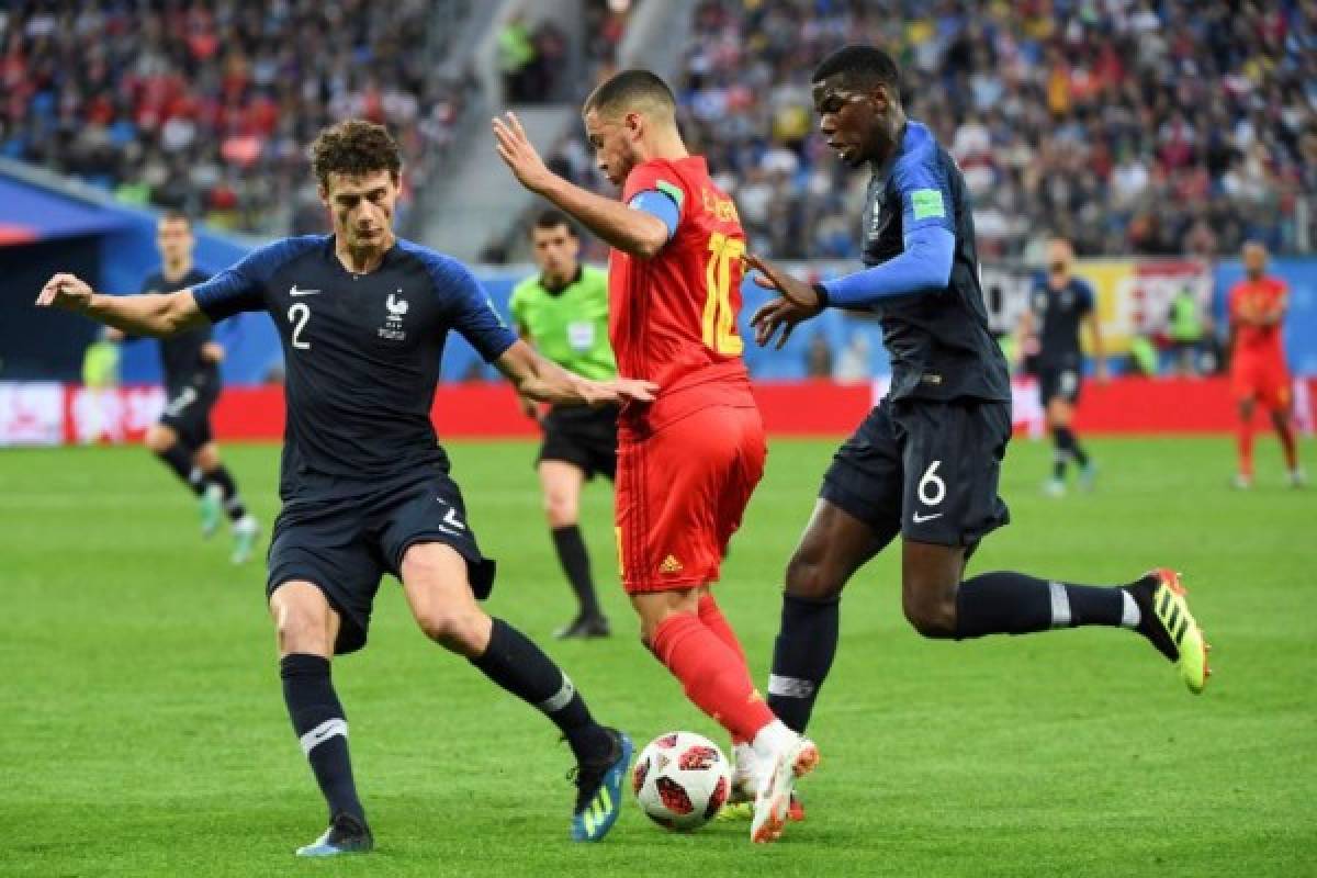 From L: France's defender Benjamin Pavard, Belgium's forward Eden Hazard and France's midfielder Paul Pogba vie for the ball during the Russia 2018 World Cup semi-final football match between France and Belgium at the Saint Petersburg Stadium in Saint Petersburg on July 10, 2018. / AFP PHOTO / Paul ELLIS / RESTRICTED TO EDITORIAL USE - NO MOBILE PUSH ALERTS/DOWNLOADS