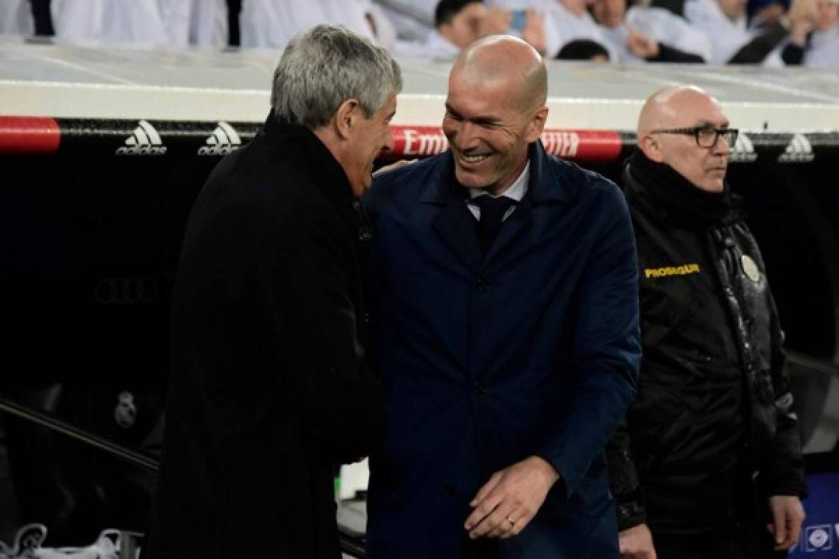 Barcelona's Spanish coach Quique Setien (L) and Real Madrid's French coach Zinedine Zidane greet each other before the Spanish League football match between Real Madrid and Barcelona at the Santiago Bernabeu stadium in Madrid on March 1, 2020. (Photo by JAVIER SORIANO / AFP)