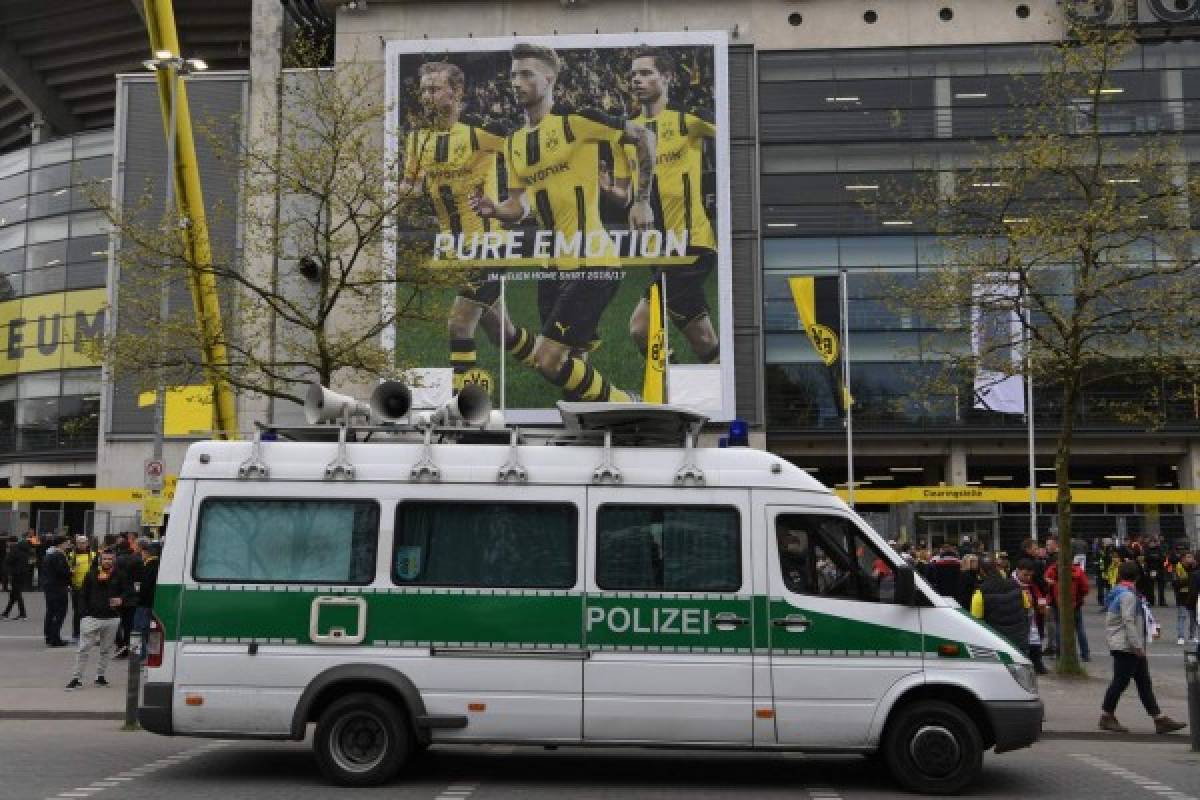 A police car stands in front of the stadium ahead the UEFA Champions League 1st leg quarter-final football match BVB Borussia Dortmund v Monaco in Dortmund, western Germany on April 12, 2017.The match had been postponed after three explosions hit German football team Borussia Dortmund's bus late on April 11, 2017 ahead of a Champions League home game. / AFP PHOTO / PATRIK STOLLARZ