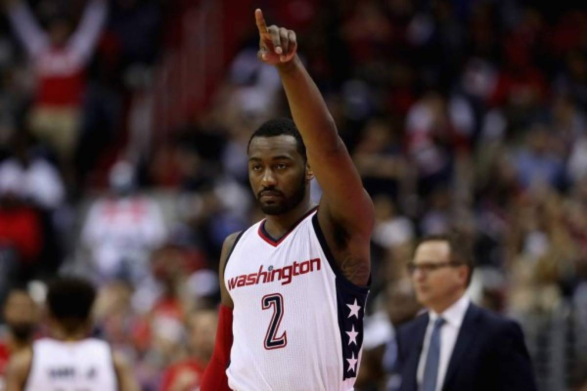 WASHINGTON, DC - APRIL 26: John Wall #2 of the Washington Wizards celebrates in the second half of their 103-99 win over the Atlanta Hawks in Game Five of the Eastern Conference Quarterfinals during the 2017 NBA Playoffs at at Verizon Center on April 26, 2017 in Washington, DC. NOTE TO USER: User expressly acknowledges and agrees that, by downloading and or using this photograph, User is consenting to the terms and conditions of the Getty Images License Agreement. Rob Carr/Getty Images/AFP
