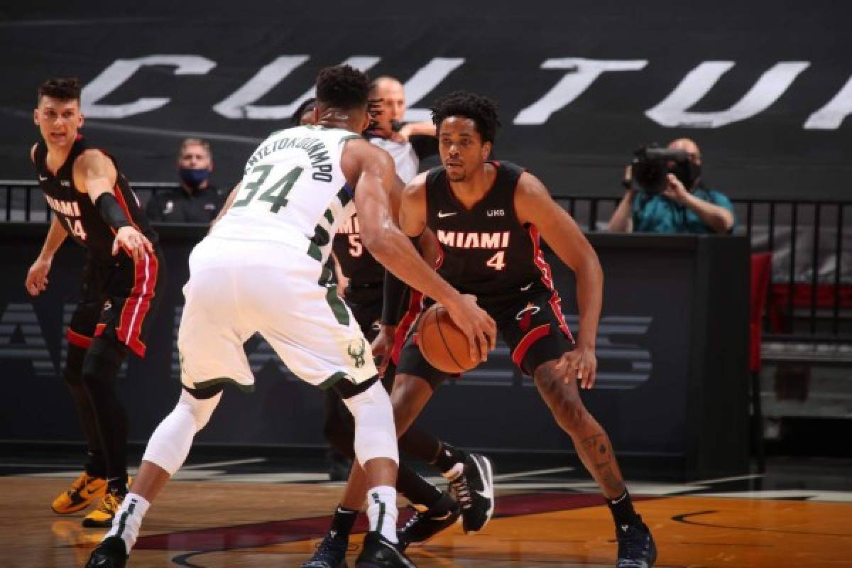 MIAMI, FL - DECEMBER 29: KZ Okpala #4 of the Miami Heat plays defense against the Milwaukee Bucks on December 29, 2020 at American Airlines Arena in Miami, Florida. NOTE TO USER: User expressly acknowledges and agrees that, by downloading and or using this Photograph, user is consenting to the terms and conditions of the Getty Images License Agreement. Mandatory Copyright Notice: Copyright 2020 NBAE Issac Baldizon/NBAE via Getty Images/AFP