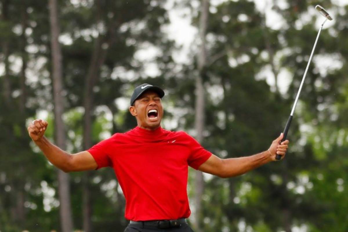 AUGUSTA, GEORGIA - APRIL 14: Tiger Woods of the United States celebrates after sinking his putt on the 18th green to win during the final round of the Masters at Augusta National Golf Club on April 14, 2019 in Augusta, Georgia. Kevin C. Cox/Getty Images/AFP