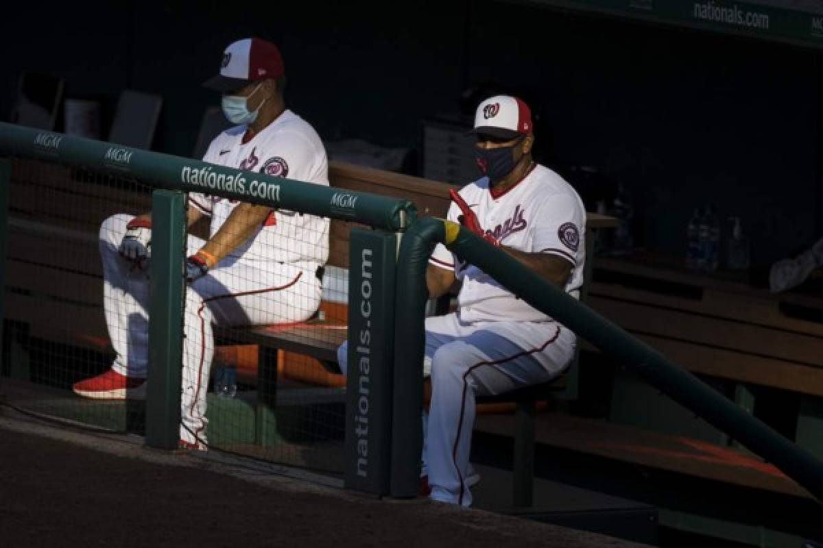 WASHINGTON, DC - JULY 18: Manager Dave Martinez #4 (R) of the Washington Nationals reacts to a play during the second inning of the game against the Philadelphia Phillies at Nationals Park on July 18, 2020 in Washington, DC. Scott Taetsch/Getty Images/AFP