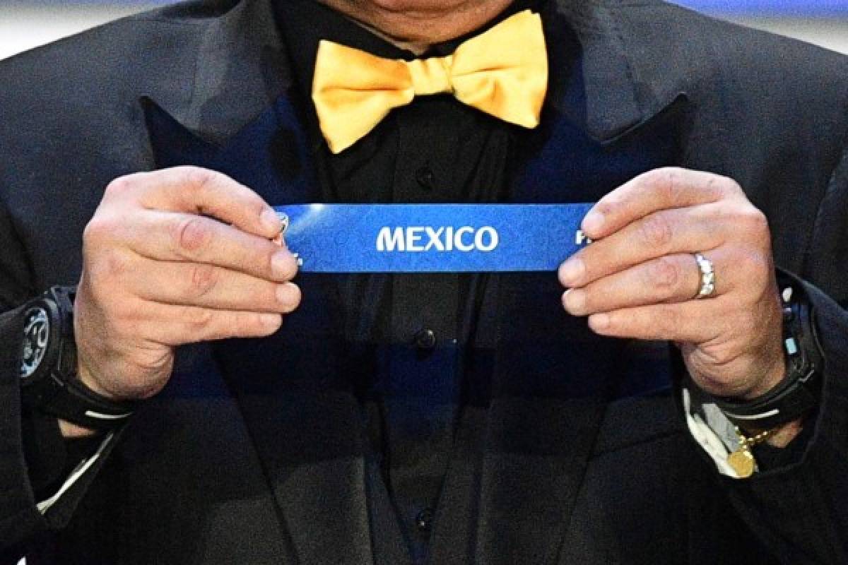 Argentina's former midfielder Diego Maradona displays the slip of Mexico during the Final Draw for the 2018 FIFA World Cup football tournament at the State Kremlin Palace in Moscow on December 1, 2017.The 2018 FIFA World Cup will be held from June 14 and July 15, 2018, in 11 Russian cities. / AFP PHOTO / Mladen ANTONOV