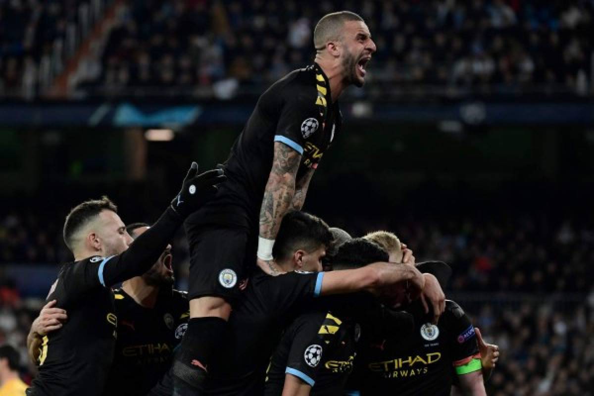 Manchester City's players celebrate their second goal scored by Manchester City's Belgian midfielder Kevin De Bruyne during the UEFA Champions League round of 16 first-leg football match between Real Madrid CF and Manchester City at the Santiago Bernabeu stadium in Madrid on February 26, 2020. (Photo by JAVIER SORIANO / AFP)