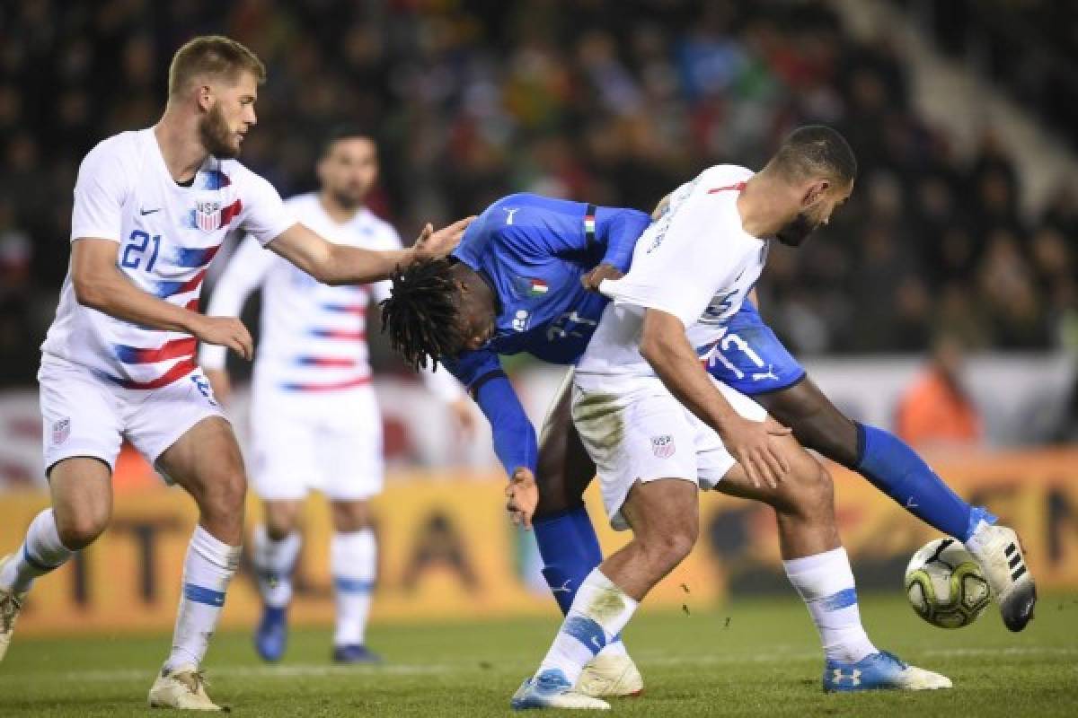 Italy's forward Moise Kan (C) and Unites States' defender Cameron Carter-Vickers (R) vie for the ball during the friendly football match between Italy and the USA at the Luminus Arena Stadium in Genk on November 20, 2018. (Photo by JOHN THYS / AFP)