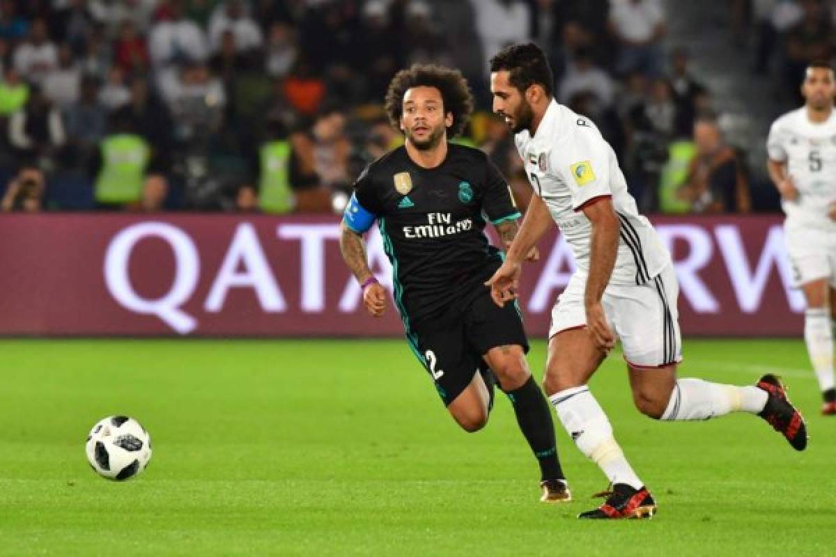 Al-Jazira's Emirati forward Ali Mabkhout (R) is marked by Real Madrid's Brazilian defender Marcelo during the FIFA Club World Cup semi-final match in the Emirati capital Abu Dhabi on December 13, 2017. / AFP PHOTO / GIUSEPPE CACACE