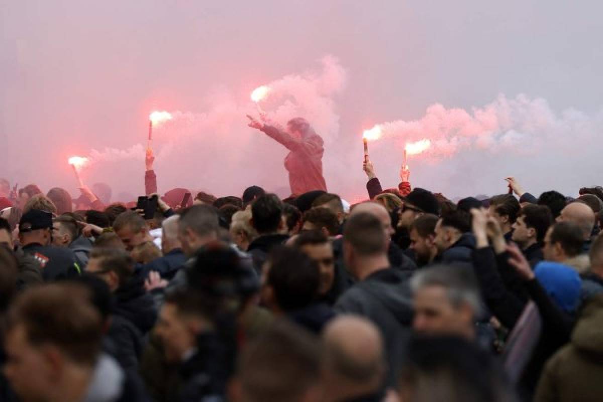 Ajax supporters burns flares in Amsterdam as they celebrate their team winning its 35th national title following the Dutch Eredivisie football match between Ajax Amsterdam and FC Emmen, on May 2, 2021. (Photo by ROBIN VAN LONKHUIJSEN / ANP / AFP) / Netherlands OUT