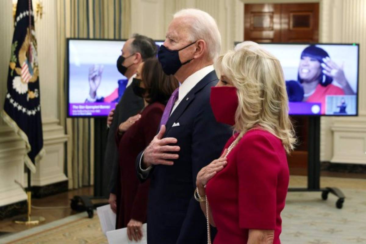WASHINGTON, DC - JANUARY 21: U.S. President Joe Biden (2nd-R), first lady Dr. Jill Biden (R), Vice President Kamala Harris (2nd-L) and Second Gentleman Doug Emhoff (L) listen to the national anthem as they watch the virtual presidential inaugural prayer service in the State Dining Room of the White House January 21, 2021 in Washington, DC. The prayer service, a tradition which dates back to the first inauguration of U.S. President George Washington, went virtual this year due to the COVID-19 pandemic. Alex Wong/Getty Images/AFP