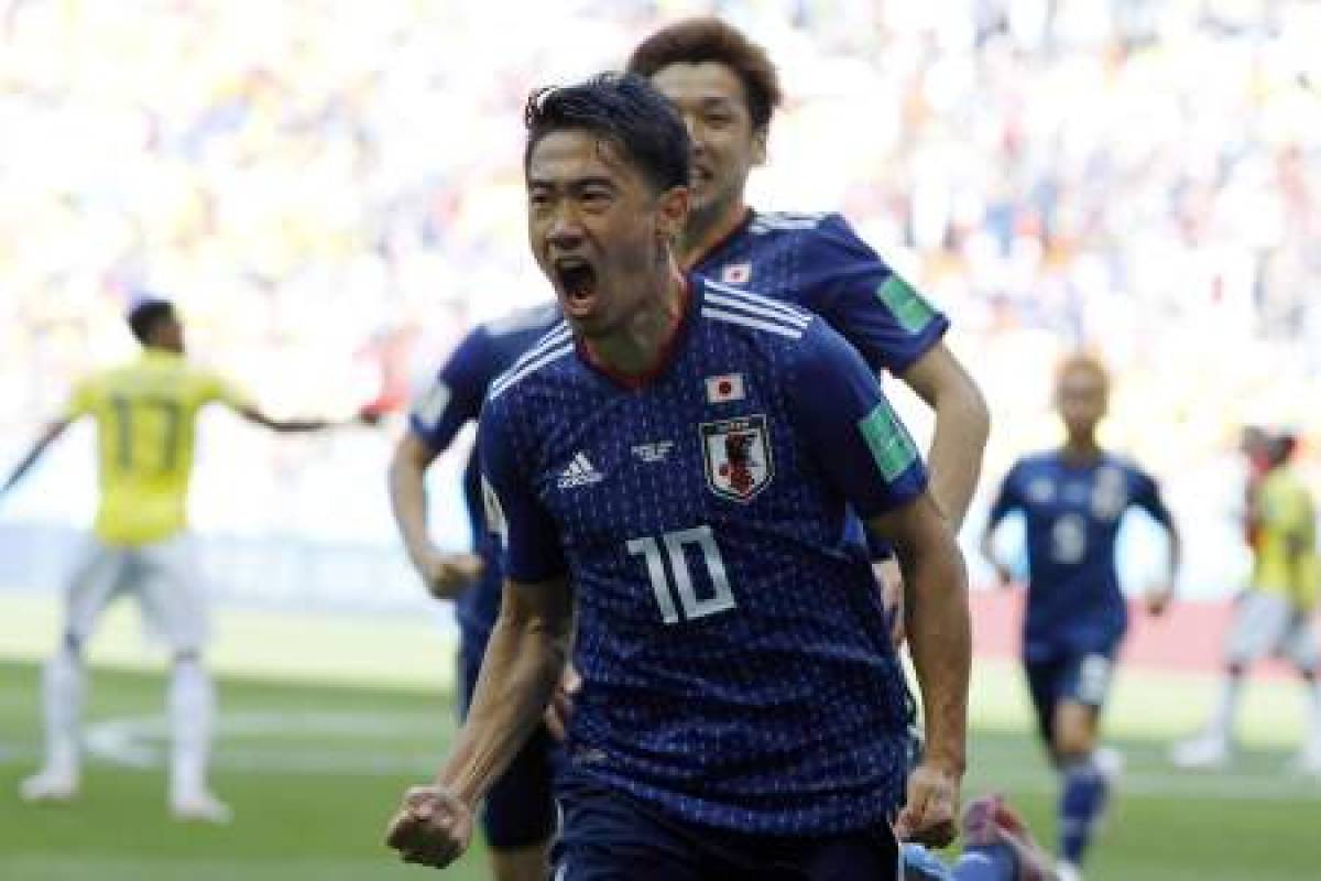 Japan's midfielder Shinji Kagawa celebrates after scoring a penalty during the Russia 2018 World Cup Group H football match between Colombia and Japan at the Mordovia Arena in Saransk on June 19, 2018. / AFP PHOTO / Jack GUEZ / RESTRICTED TO EDITORIAL USE - NO MOBILE PUSH ALERTS/DOWNLOADS