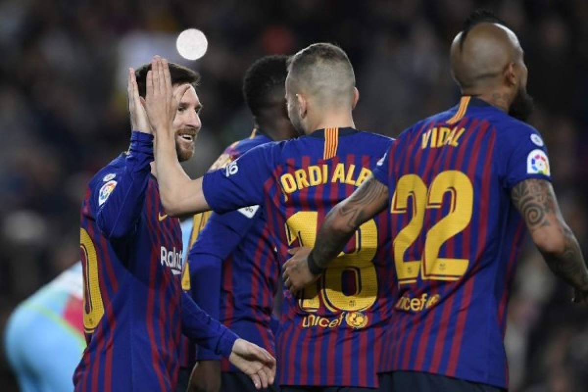 Barcelona's Argentinian forward Lionel Messi (L) celebrates with Barcelona's Spanish defender Jordi Alba after scoring during the Spanish league football match between FC Barcelona and Rayo Vallecano de Madrid at the Camp Nou stadium in Barcelona on March 9, 2019. (Photo by LLUIS GENE / AFP)