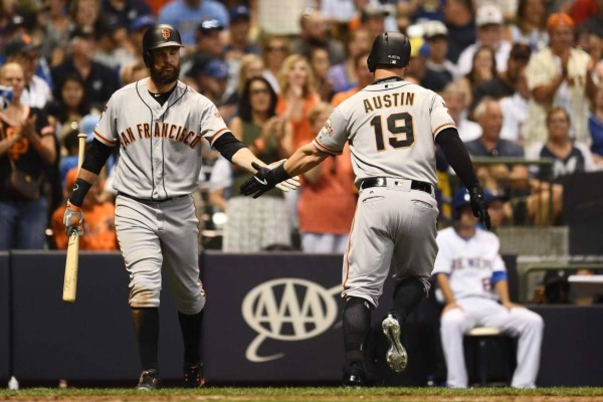 MILWAUKEE, WISCONSIN - JULY 12: Tyler Austin #19 of the San Francisco Giants is congratulated by Brandon Belt #9 following a home run against the Milwaukee Brewers during the eighth inning at Miller Park on July 12, 2019 in Milwaukee, Wisconsin. Stacy Revere/Getty Images/AFP