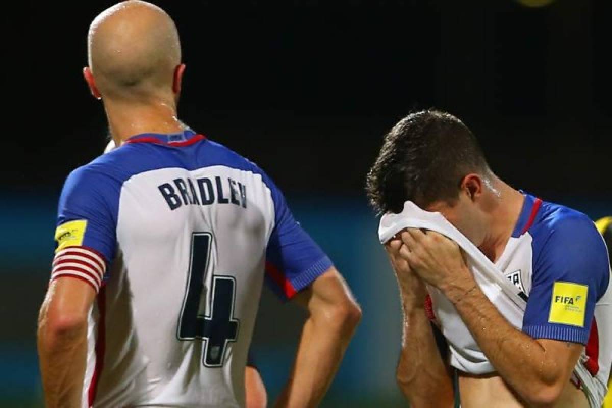 COUVA, TRINIDAD AND TOBAGO - OCTOBER 10: Michael Bradley (L) and Christian Pulisic (R) of the United States mens national team react to their loss against Trinidad and Tobago during the FIFA World Cup Qualifier match between Trinidad and Tobago at the Ato Boldon Stadium on October 10, 2017 in Couva, Trinidad And Tobago. Ashley Allen/Getty Images/AFP
