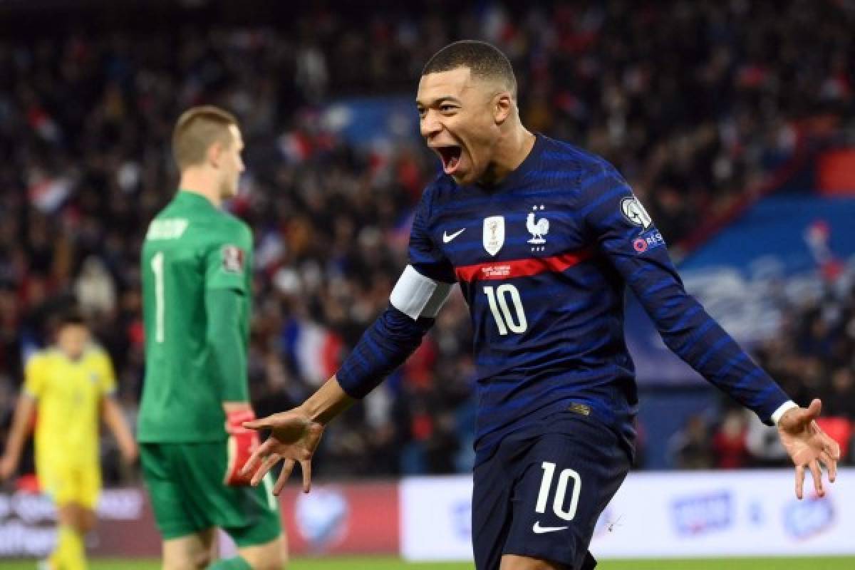 France's forward Kylian Mbappe celebrates after scoring a goal during the FIFA World Cup 2022 qualification football match between France and Kazakhstan at the Parc des Princes stadium in Paris, on November 13, 2021. (Photo by FRANCK FIFE / AFP)