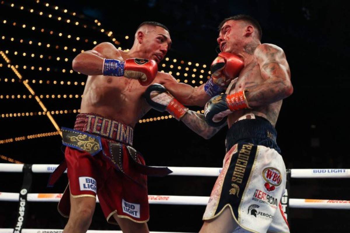 NEW YORK, NEW YORK - NOVEMBER 27: Teofimo Lopez punches George Kambosos during their championship bout for Lopezs Undisputed Lightweight title at The Hulu Theater at Madison Square Garden on November 27, 2021 in New York, New York. Al Bello/Getty Images/AFP (Photo by AL BELLO / GETTY IMAGES NORTH AMERICA / Getty Images via AFP)