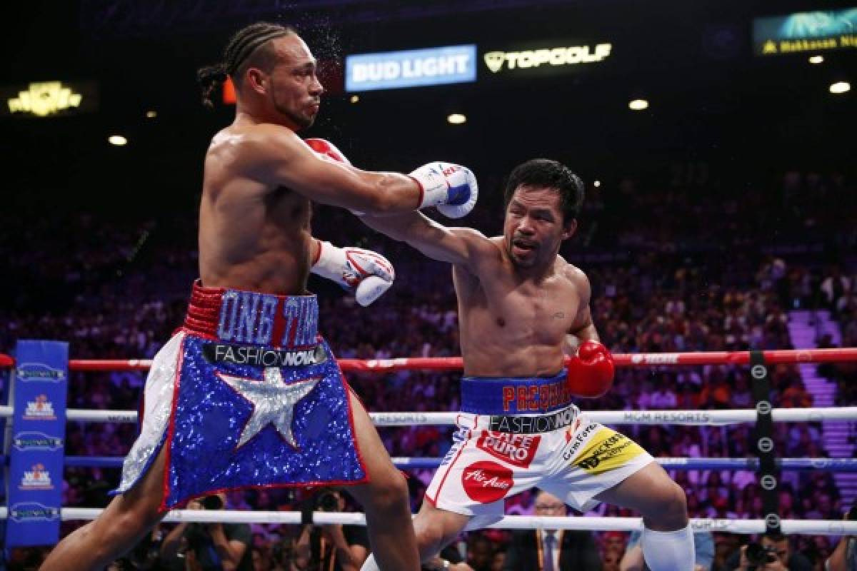 LAS VEGAS, NEVADA - JULY 20: Manny Pacquiao (R) connects with a punch on Keith Thurman during their WBA welterweight title fight at MGM Grand Garden Arena on July 20, 2019 in Las Vegas, Nevada. Steve Marcus/Getty Images/AFP== FOR NEWSPAPERS, INTERNET, TELCOS & TELEVISION USE ONLY ==