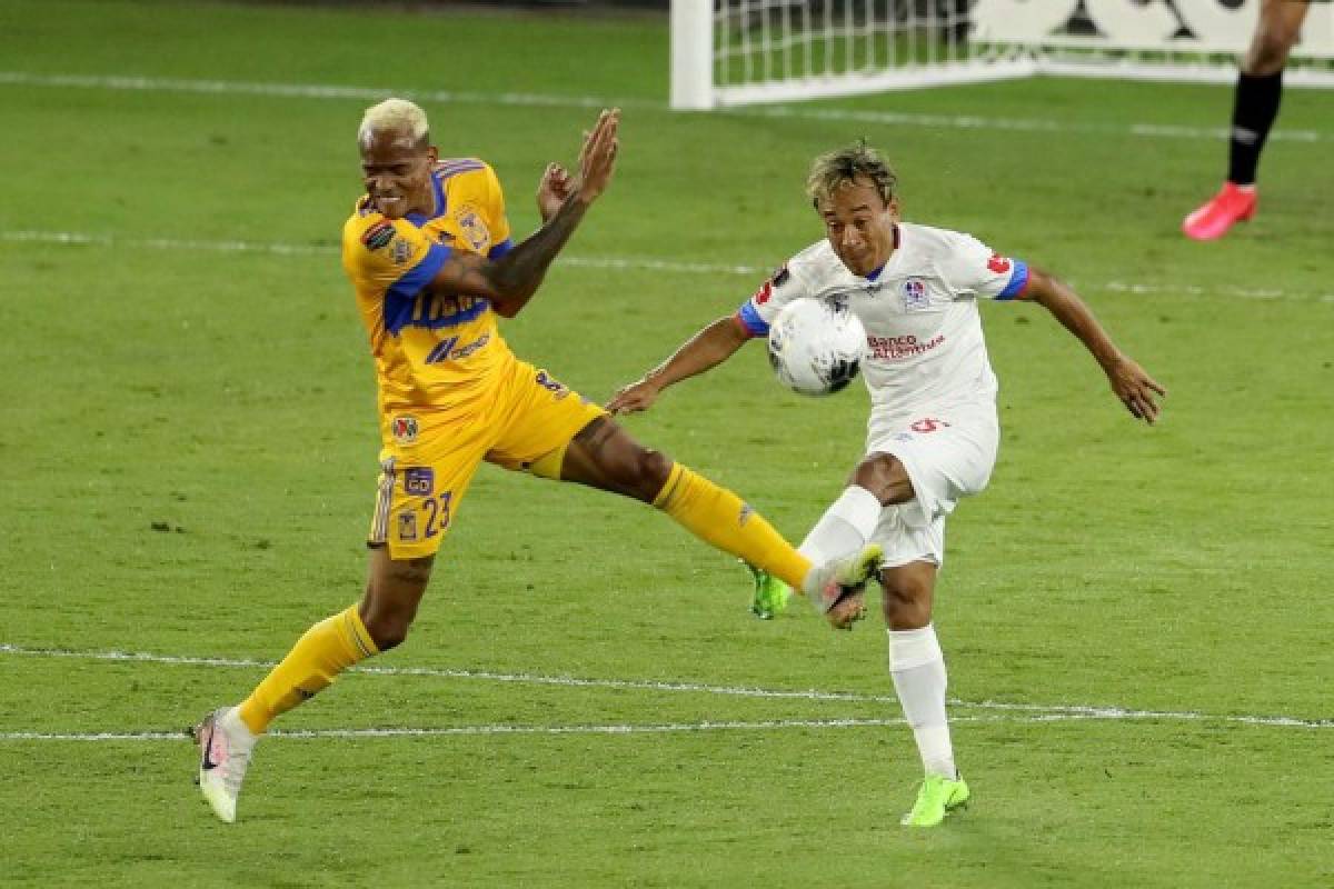 ORLANDO, FL - DECEMBER 19: Luis Quinones #23 of Tigres UANL and Edwin Rodriguez #15 of CD Olimpia fight for the ball during the CONCACAF Champions League semifinal game at Exploria Stadium on December 19, 2020 in Orlando, Florida. Alex Menendez/Getty Images/AFP== FOR NEWSPAPERS, INTERNET, TELCOS & TELEVISION USE ONLY ==