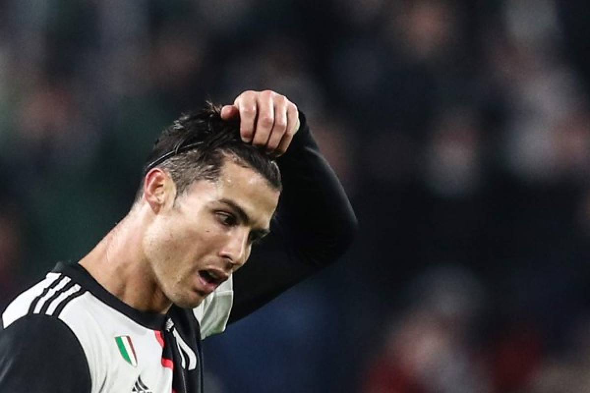 Juventus' Portuguese forward Cristiano Ronaldo takes off his hair hoop at the end of the UEFA Champions League Group D football match Juventus Turin vs Atletico Madrid on November 26, 2019 at the Juventus Allianz stadium in Turin. (Photo by Isabella BONOTTO / AFP)