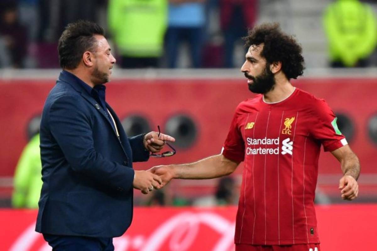 Liverpool's Egyptian midfielder Mohamed Salah (R) speaks with Monterrey's coach Antonio Mohamed during the 2019 FIFA Club World Cup semi-final football match between Mexico's Monterrey and England's Liverpool at the Khalifa International Stadium in the Qatari capital Doha on December 18, 2019. - Liverpool will face Flamengo in the Final of the FIFA Club World Cup on December 21. (Photo by Giuseppe CACACE / AFP)