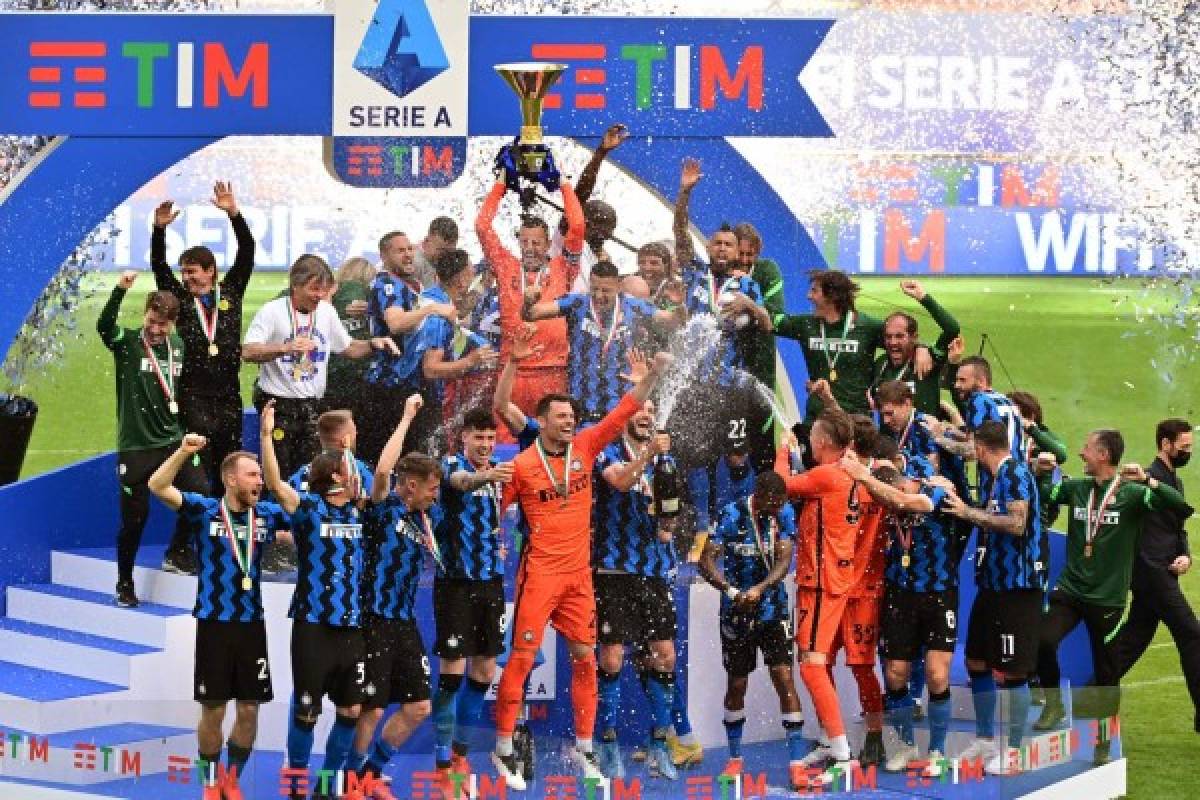 Inter Milan's Slovenian goalkeeper Samir Handanovic (Top C) lifts the Scudetto Trophy as Inter players and staff celebrate winning the Serie A 2020-2021 championship after their last Italian Serie A football match Inter Milan vs Udinese on May 23, 2021 at the San Siro stadium in Milan. (Photo by MIGUEL MEDINA / AFP)