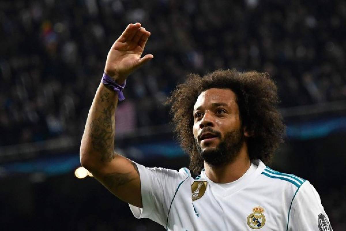 Real Madrid's Brazilian defender Marcelo celebrates after scoring during the UEFA Champions League round of sixteen first leg football match Real Madrid CF against Paris Saint-Germain (PSG) at the Santiago Bernabeu stadium in Madrid on February 14, 2018. / AFP PHOTO / GABRIEL BOUYS
