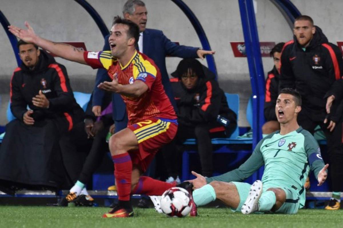 Portugal's forward Cristiano Ronaldo (R) and Andorra's midfielder Victor Rodriguez react during the FIFA World Cup 2018 football qualifier between Andorra and Portugal at the Municipal Stadium in Andorra la Vella, on October 7, 2017. / AFP PHOTO / PASCAL PAVANI